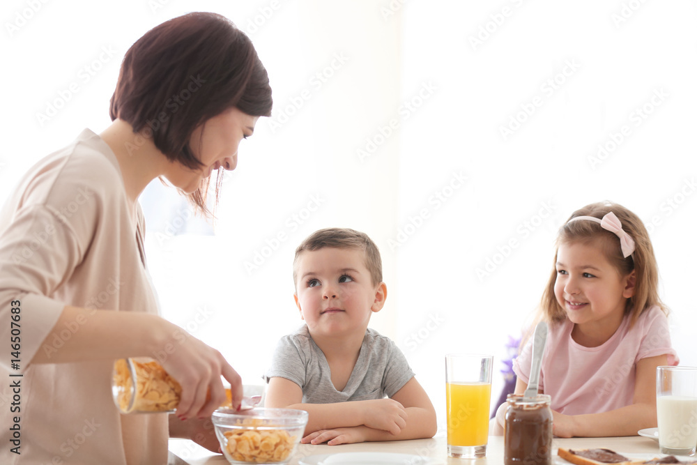 Mother and children having breakfast at home Mother and children having breakfast at home