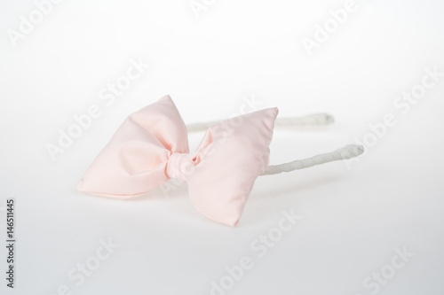 Fashion accessory for little girls with style, creamy bow on white background