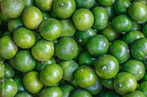 Fresh limes close up background. Healthy food. Harvest in the market, Thailand