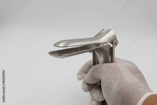 speculum in hand doctor on white background.Medical concept .