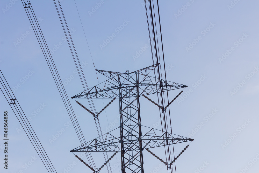 high voltage electric tower and cable against cloudy sky, copyspace on the right