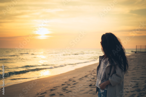 Brunette girl on the background of the sea sunset