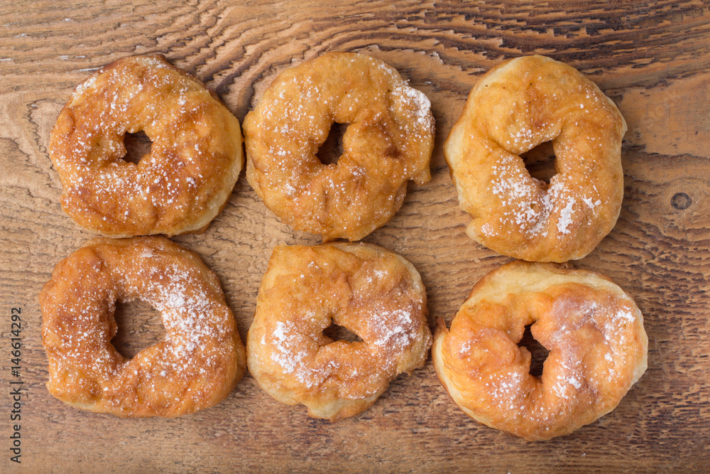 sugary donut on a wooden background