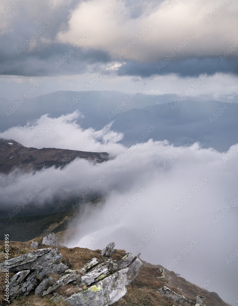 Mountain valley in the clouds. Natural summer landscape