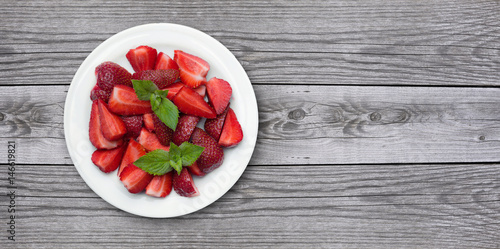 Juicy strawberrys on old wood background. Healthy and tasty food