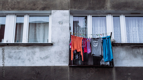 Washed clothes hung out to dry outside the window of a communist style apartment block in Wroclaw, Poland.
