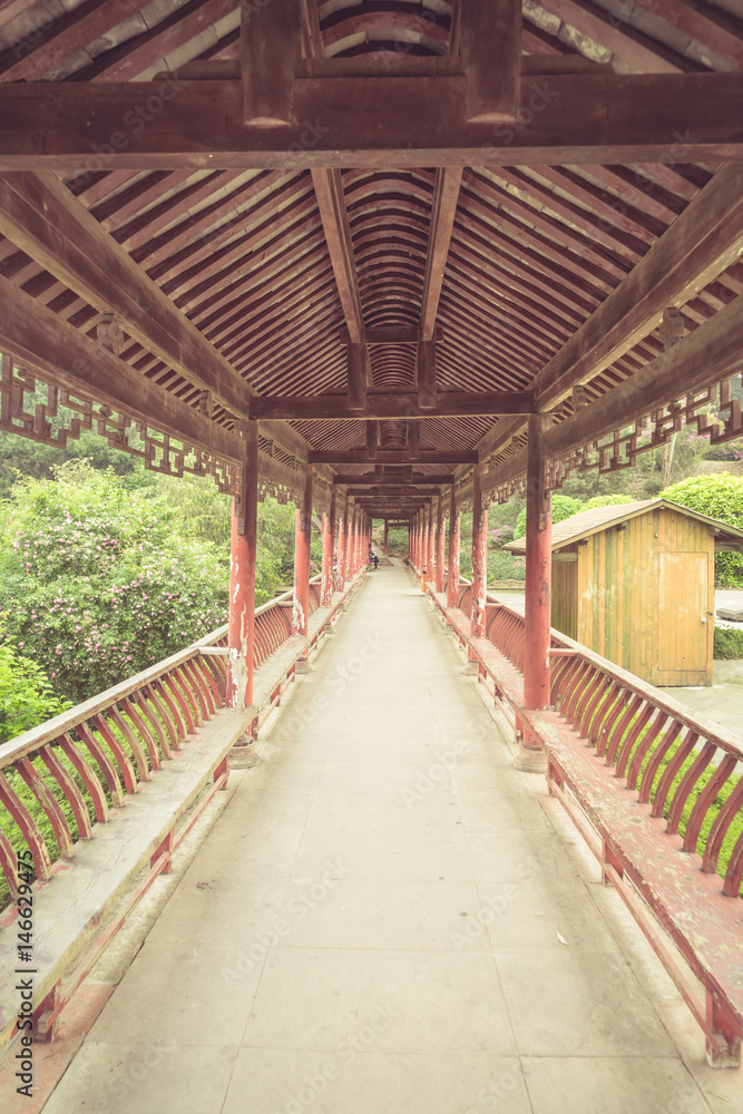 Fototapeta premium long corridor of Chinese traditional architecture in a park,shot in city of China.