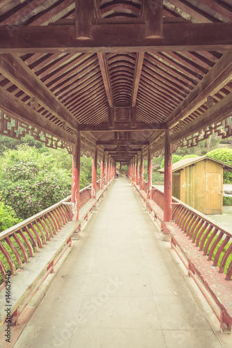 long corridor of Chinese traditional architecture in a park,shot in city of China. © fanjianhua