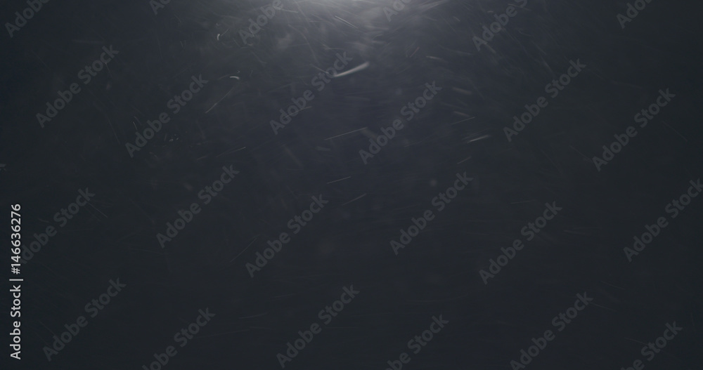 dust particles fast moving over black background, 4k photo
