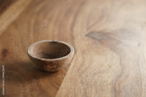 small wooden bowl on wood table with copy space