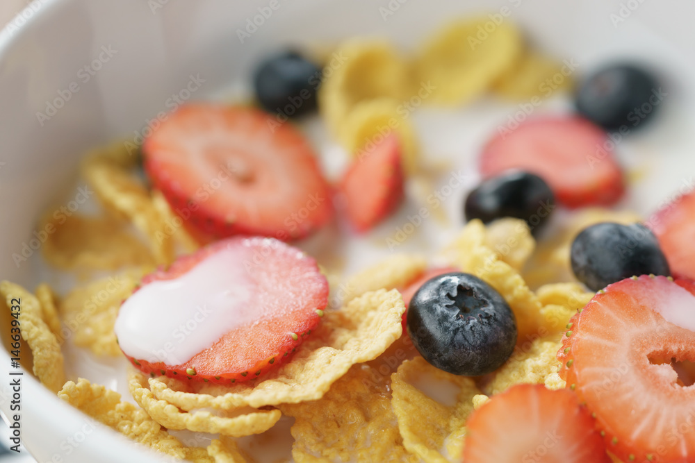 closeup of healthy breakfast with corn flakes and berries in white bowl, macro shot closeup of healthy breakfast with corn flakes and berries in white bowl, macro shot
