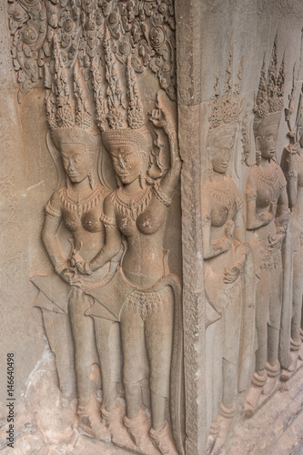 Khmer classical nymphs  and dancers shown in stone - An Apsara (also spelled as Apsarasa) in Angkor Wat temple, Siem Reap, Cambodia. photo