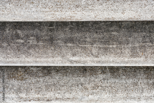 Old concrete texture with scuffs, chips and scratches predominantly in gray colors