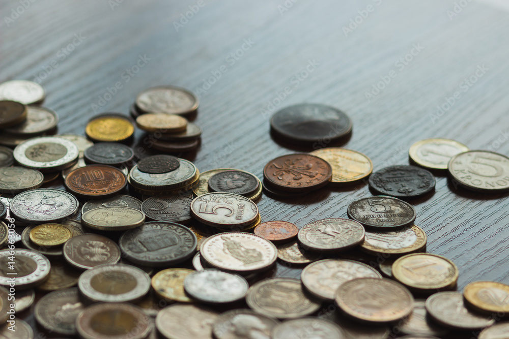 Different gold and silver collector's coins on the wooden table Different gold and silver collector's coins on the wooden table