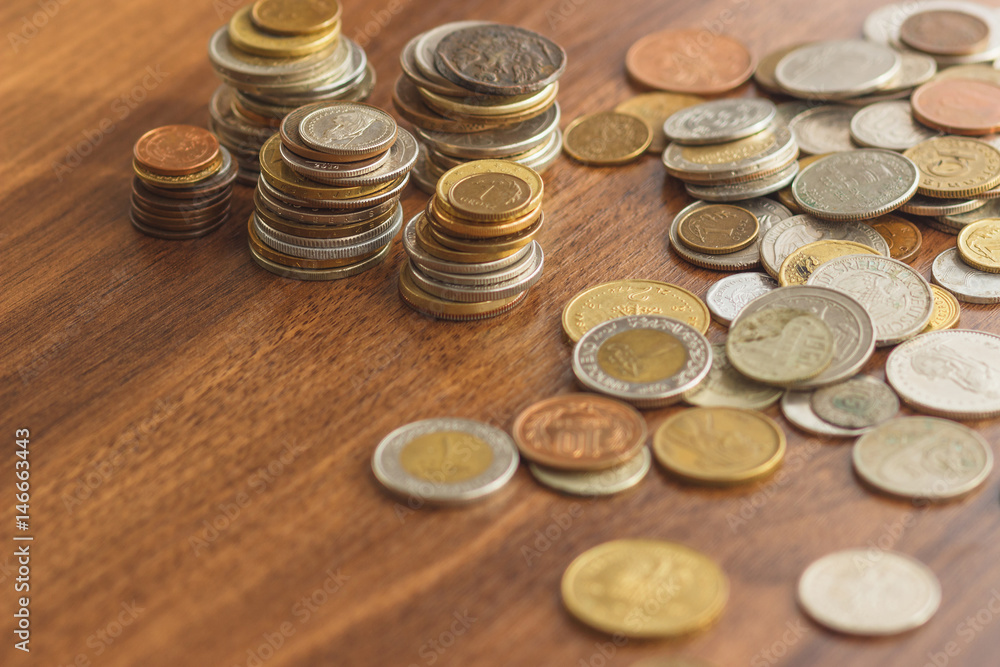 Different gold and silver collector's coins on the wooden table Different gold and silver collector's coins on the wooden table