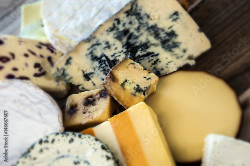Selection of cheeses, centre in focus, with text space.