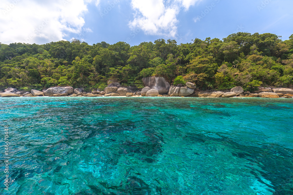 Tropical island beach and clear blue lagoon water with blue sky at Similan  Island, Phang Nga Province, South of Thailand 
