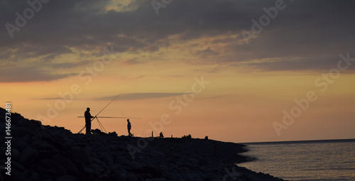 People fishing at sunset 