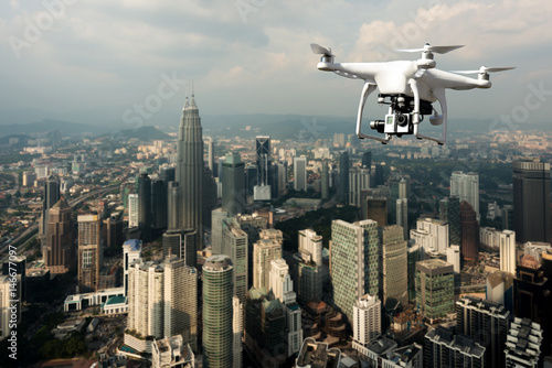 Drone with high resolution digital camera flying over Kuala Lumpur city at Kuala Lumpur, Malaysia.