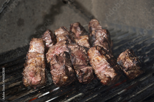 beef steak cooking on an open flame grill