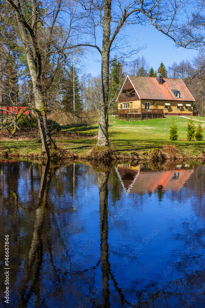 House with garden by a river House with garden by a river