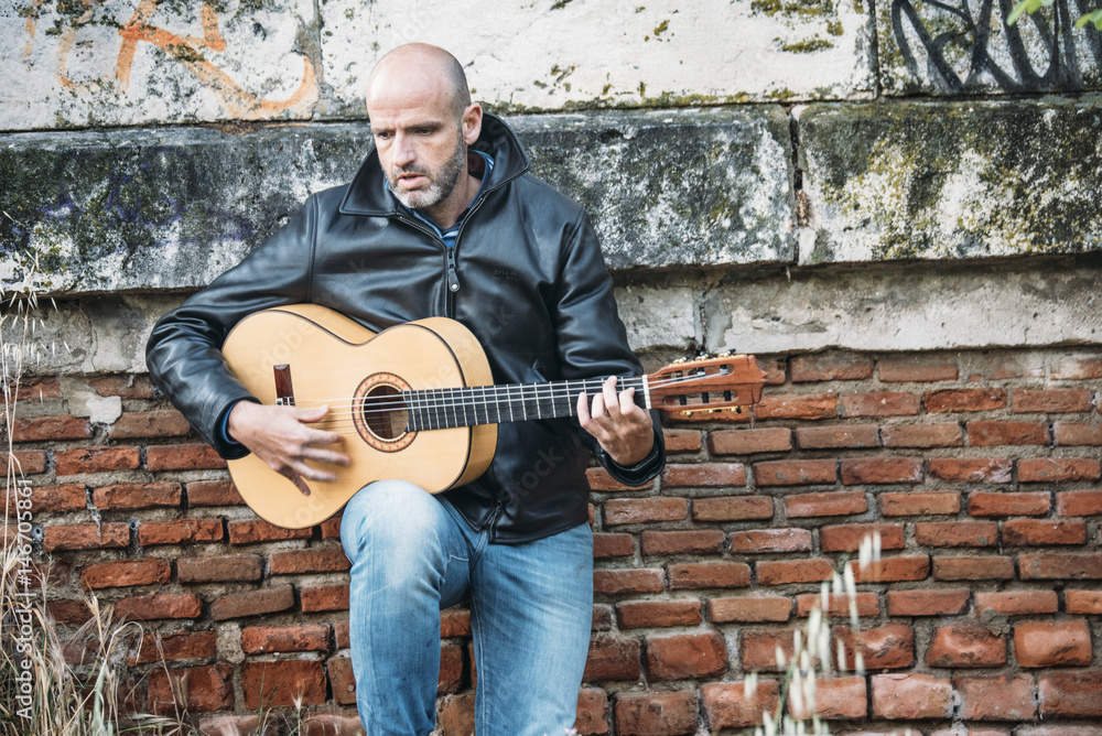 Man with guitar in the field Man with guitar in the field