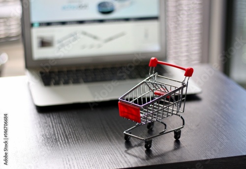 Red Shopping Cart in front of Laptop