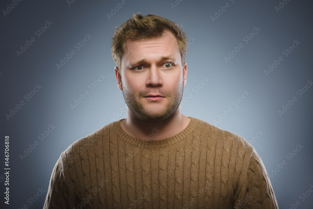 Close up face of discouraged man isolated grey background Close up face of discouraged man isolated grey background