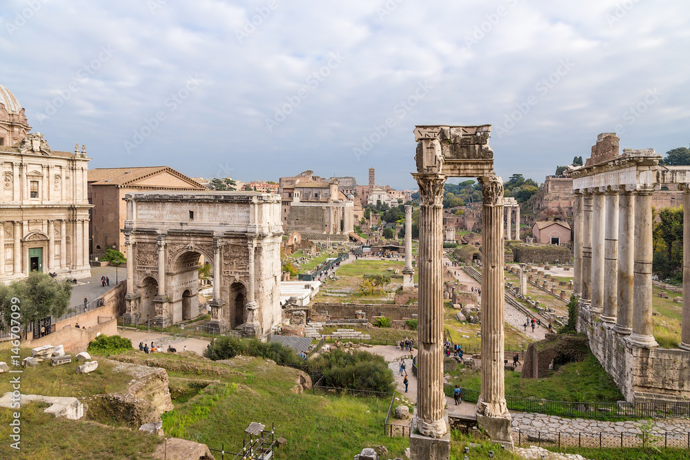 Rome, Italy. The ancient ruins of the Roman Forum: the temple of Saturn, the temple of Vespasian, the arch of Septimius Severus
