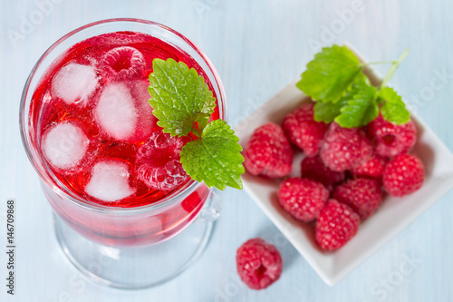 Alcohol cocktail with raspberries and mint
