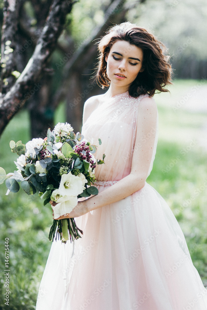 Portrait of beautiful bride in the park