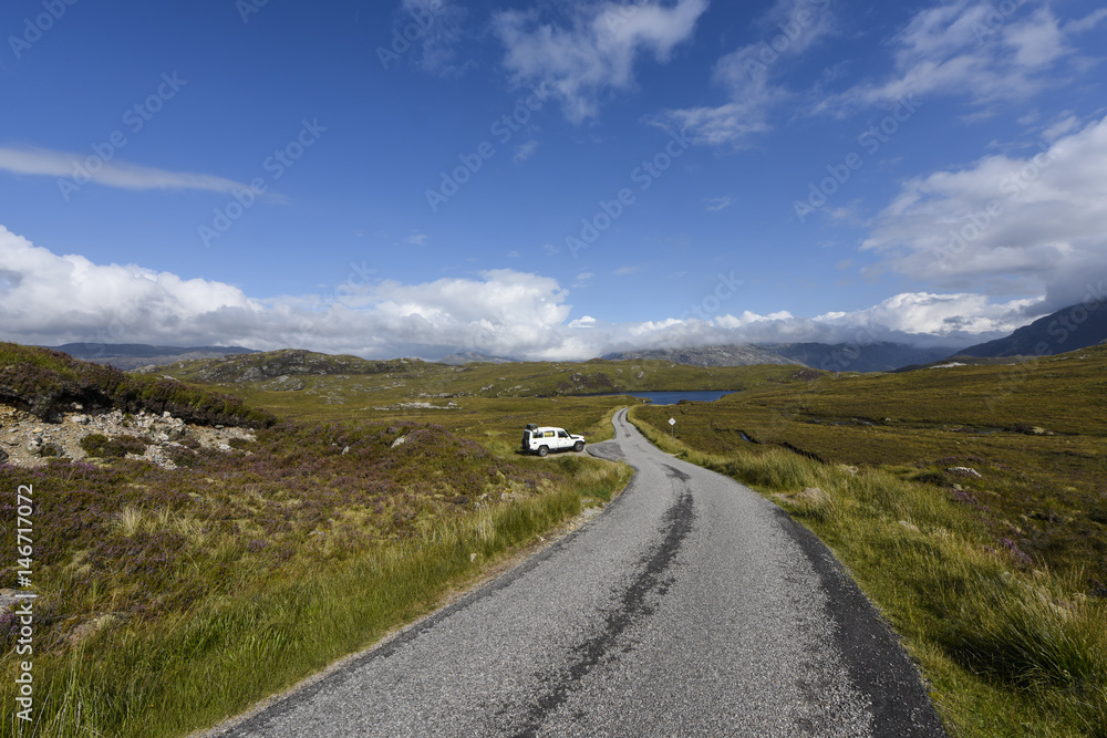 Driving on a loneley road through the beautiful scottish moorland, Assynt, Scotland
