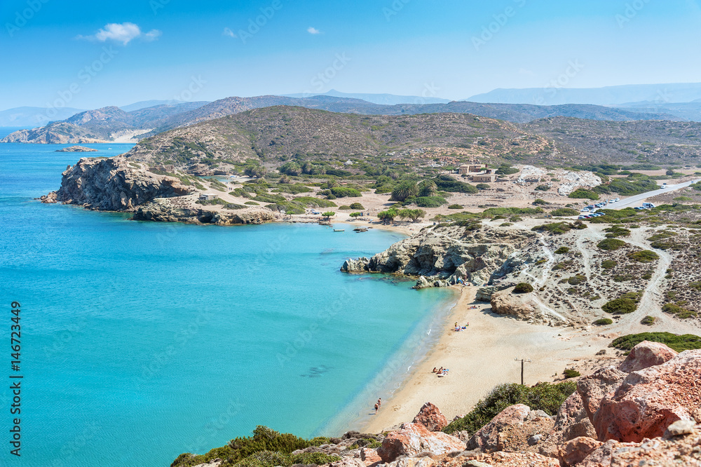 Sandy beach and lagoon with clear blue water at Crete island near Sitia town, Greece.
