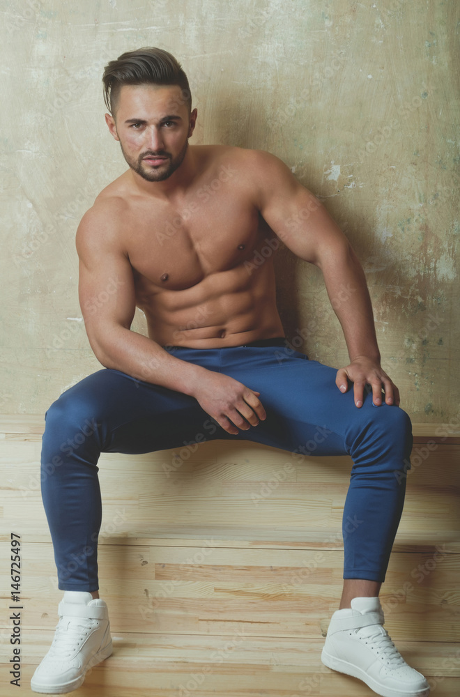 Handsome athletic man with sexy torso sitting Handsome athletic man with sexy torso sitting