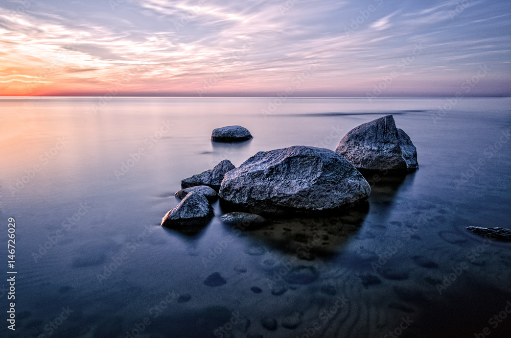 The stones in the sea at sunset.