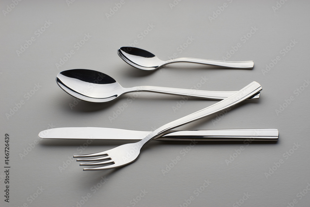 Cutlery. Set with fork, knife and spoons on gray background Cutlery. Set with fork, knife and spoons on gray background