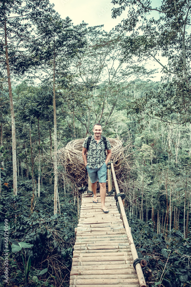 Young man in rainforest of tropical Bali island, Indonesia. Young man in rainforest of tropical Bali island, Indonesia.