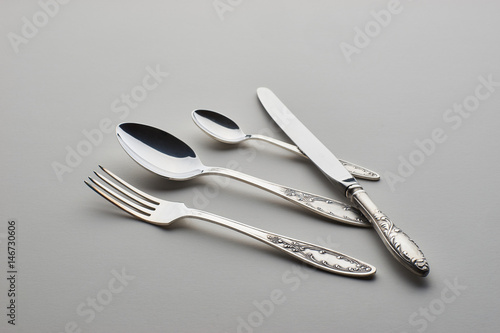Cutlery. Set with fork  knife and spoons on gray background