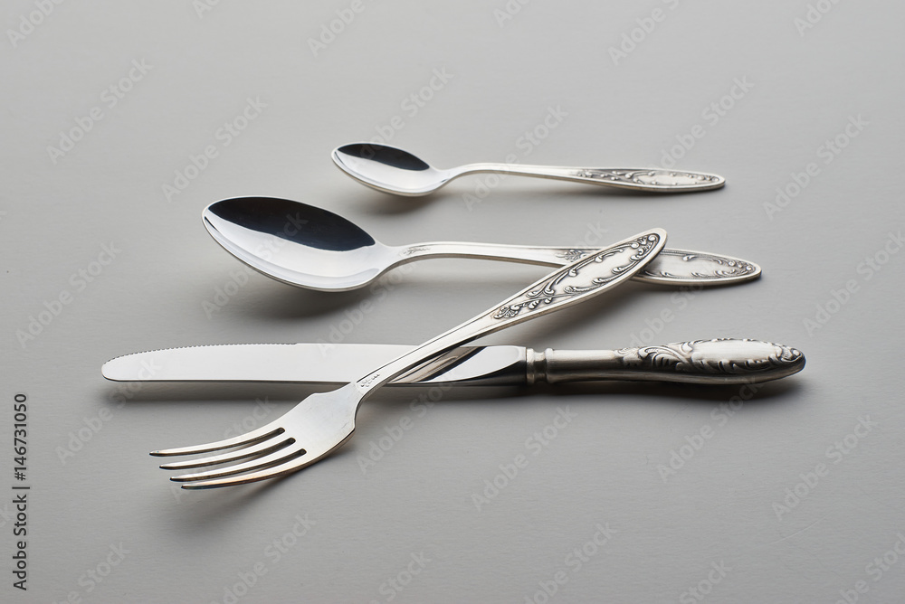 Cutlery. Set with fork, knife and spoons on gray background Cutlery. Set with fork, knife and spoons on gray background