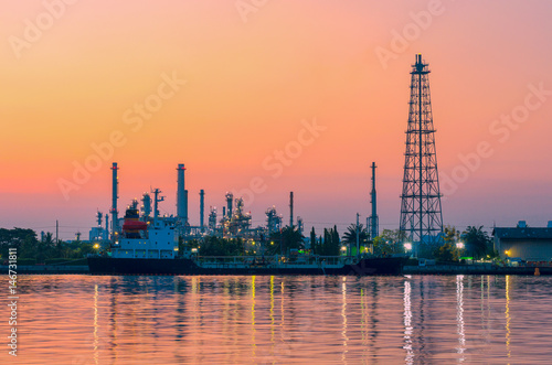 silhouette oil refinery industry at morning with golden sky. © thithawat