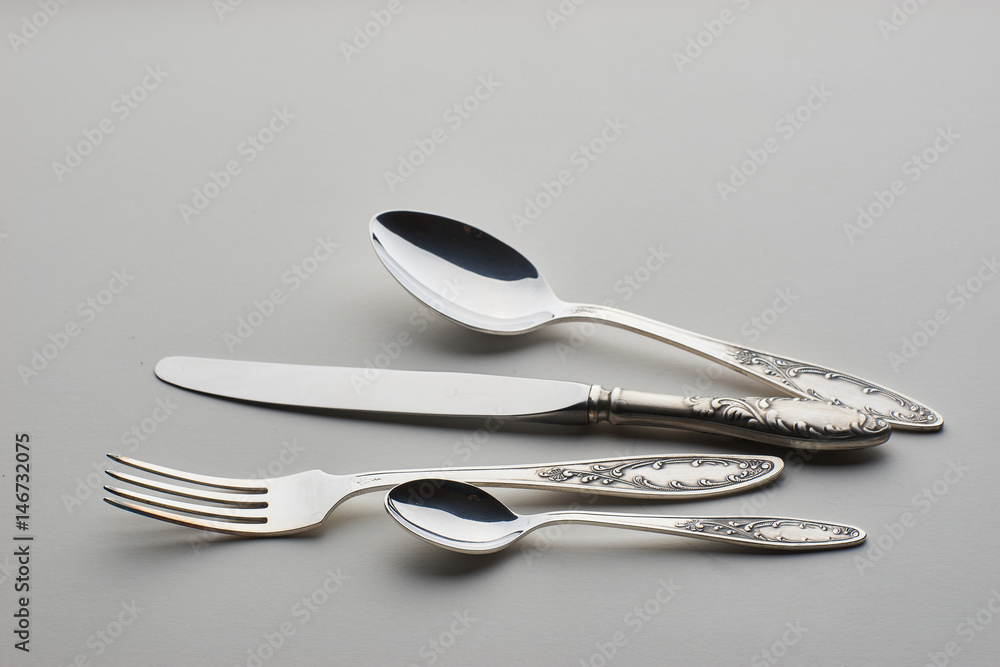 Cutlery. Set with fork, knife and spoons on gray background Cutlery. Set with fork, knife and spoons on gray background