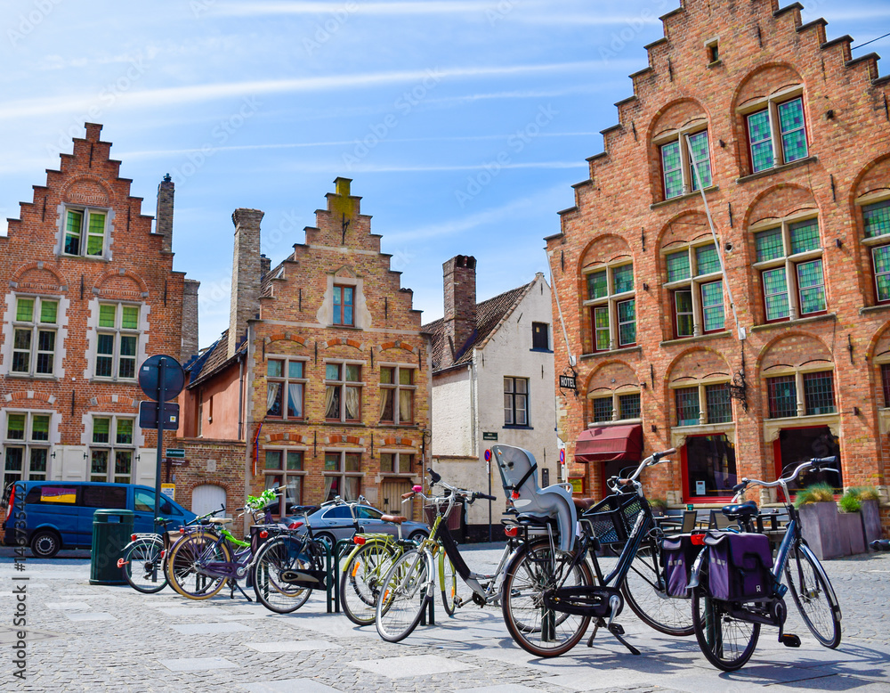 Fototapeta premium Bicycles are parked in front of historical medieval brick buidlings