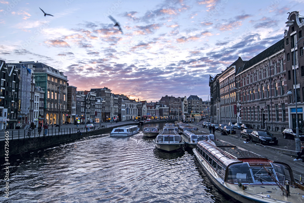 cityscape of the famous canals at Twilight time in Amsterdam, Netherlands