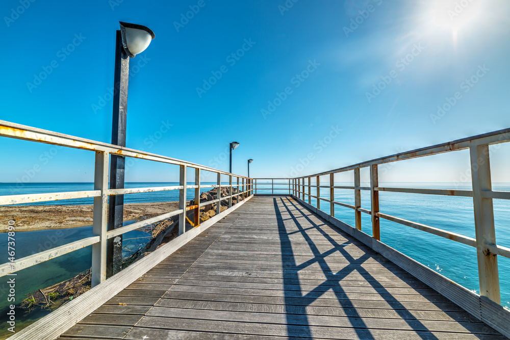 Naklejka premium Wooden boardwalk in Marina di Cardedu