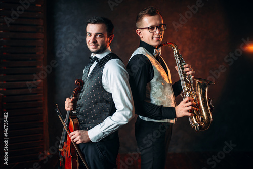 Saxophonist with sax and violinst with violin duet photo