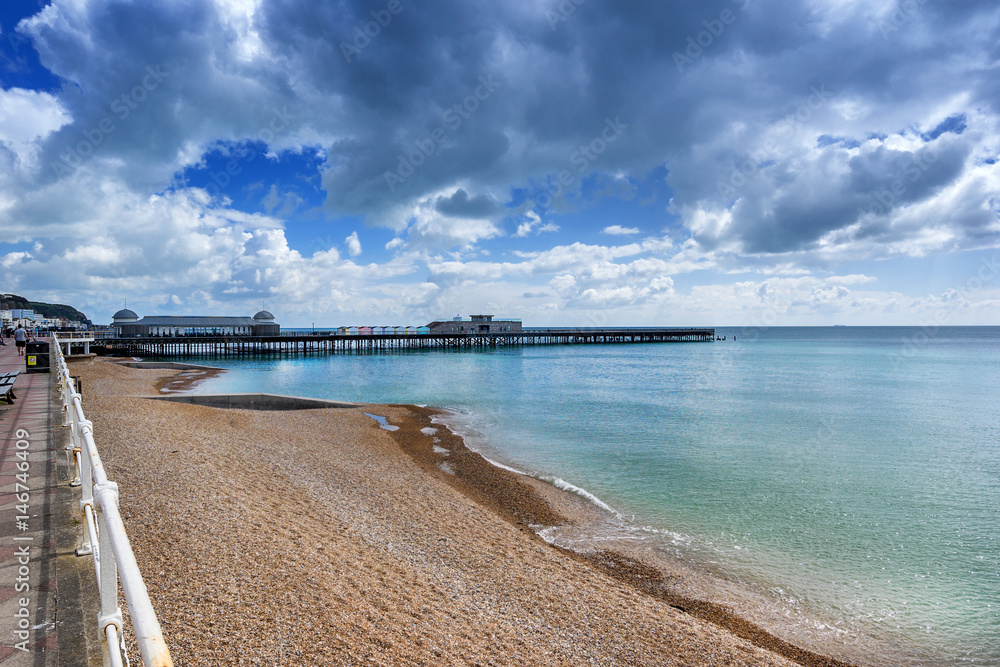 Hastings pier and beach in the county of Sussex in England