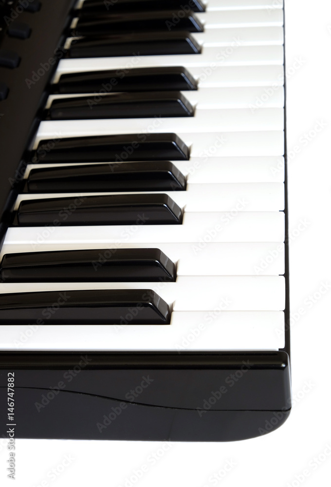 Piano keyboard with white and black keys on white background side view vertical photo close up Piano keyboard with white and black keys on white background side view vertical photo close up