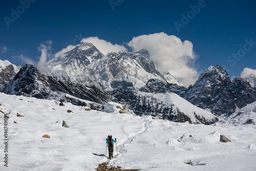 Trekker is walking by Renjo La pass in Everest region photo
