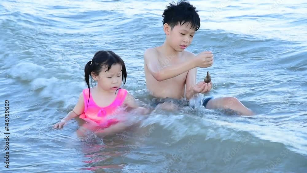 Asian children having fun in water outdoors. Asian children having fun in water outdoors.