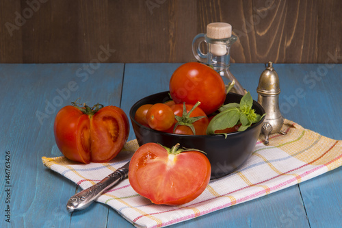 Fresh tomatoes with herbs on a kitchen board